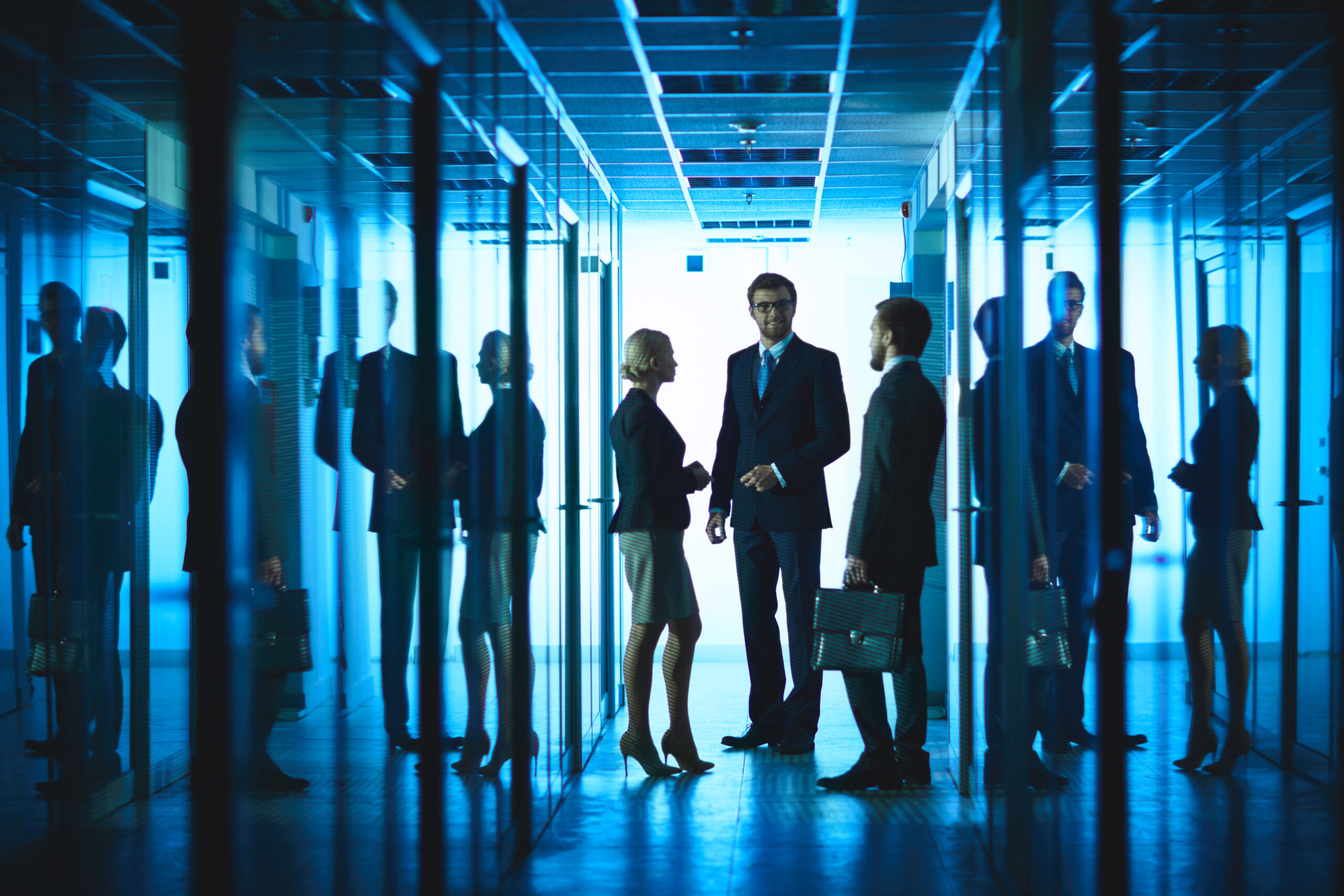 Group of business people having meeting in corridor of business center