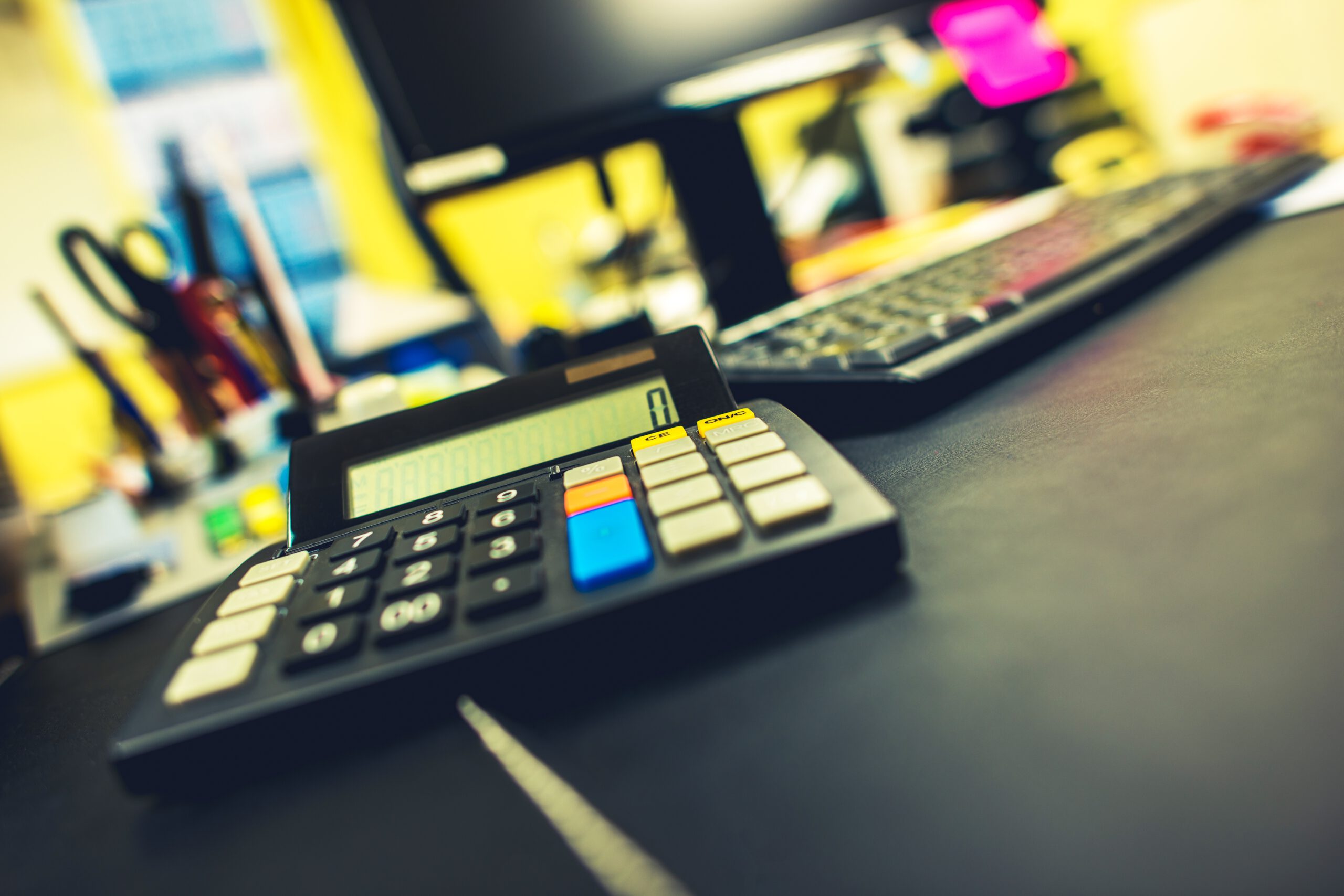 Office and Accounting Concept. Compact Calculator Device on the Accountant Desk.